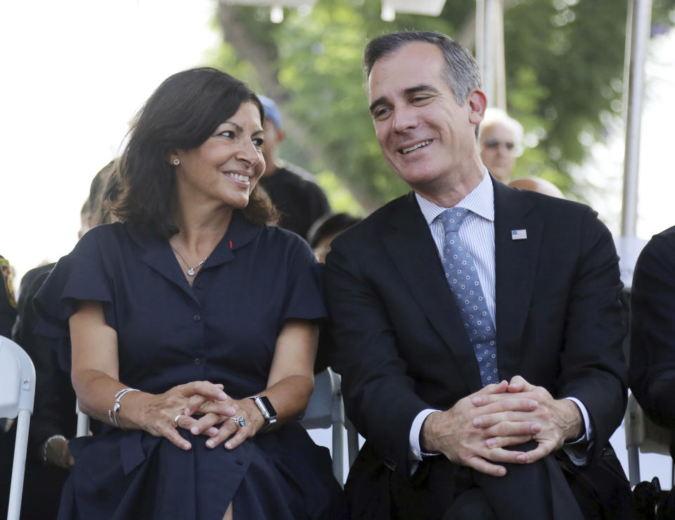 Paris Mayor Anne Hidalgo and Los Angeles Mayor Eric Garcetti speaks during a ceremony marking the 17th anniversary of the Sept. 11, 2001 terrorist attacks on America, at the Los Angeles Fire Department's training center Tuesday, Sept. 11, 2018. The mayors of Paris and Los Angeles met Tuesday ahead of a global climate summit to memorialize the victims of the 9/11 attacks on the U.S., and to talk about the commonalities between the two cities amid an increasingly divided world. The mayors then helped pack lunches for the needy. (AP Photo/Reed Saxon)