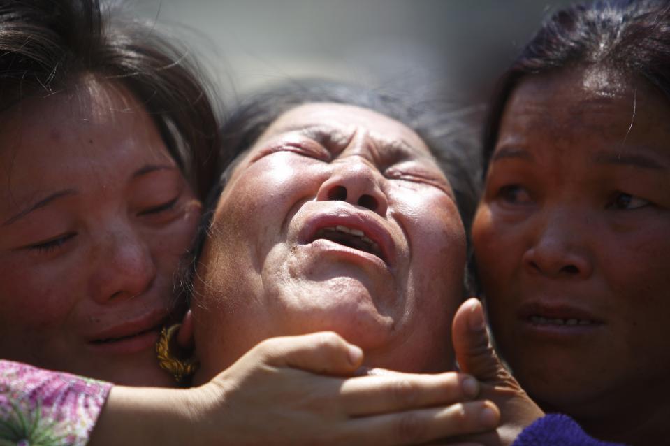 A family member a Sherpa climber is comforted by her relatives during a funeral rally of Nepali Sherpa climbers in Kathmandu April 21, 2014. (REUTERS/Navesh Chitrakar)