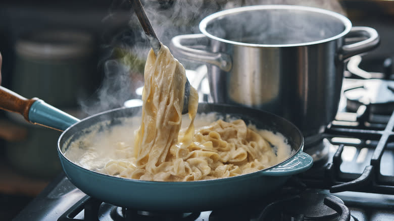 Making Alfredo pasta on stovetop