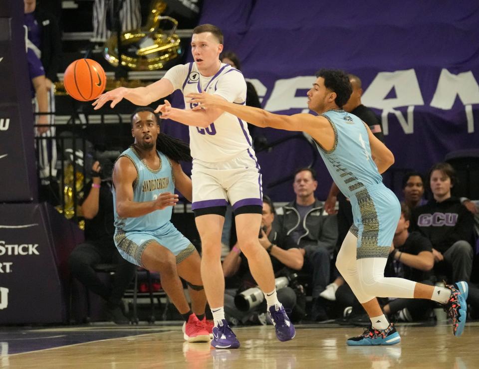 Nov 9, 2022; Phoenix, Ariz., U.S.;  Grand Canyon forward Noah Baumann (20) passes the ball out while defended by San Diego Christian guard Josh O’Campo (1) during the first half at GCU Arena. Mandatory Credit: Michael Chow-Arizona Republic