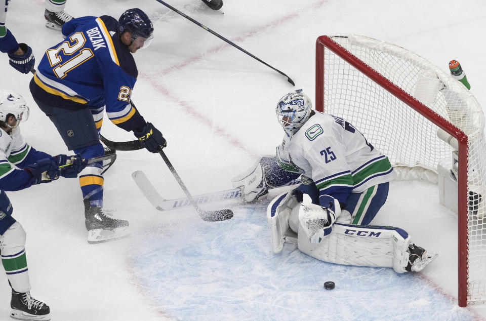 Vancouver Canucks goalie Jacob Markstrom (25) stops St. Louis Blues' Tyler Bozak (21) during the second period in Game 1 of an NHL hockey Stanley Cup first-round playoff series, Wednesday, Aug. 12, 2020, in Edmonton, Alberta. (Jason Franson/The Canadian Press via AP)