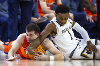 Notre Dame's JJ Starling (1) and Syracuse's Joseph Girard III, left, fight for a loose ball during the first half of an NCAA college basketball game on Saturday, Dec. 3, 2022 in South Bend, Ind. (AP Photo/Michael Caterina)
