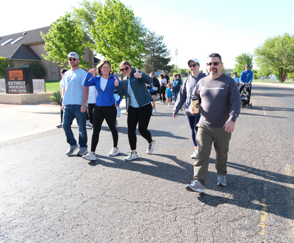 Attendees enjoy their walk at the "Walk a Mile in Their Shoes,” a one-mile run/walk event at The Bridge Children's Advocacy Center in Amarillo on Saturday.