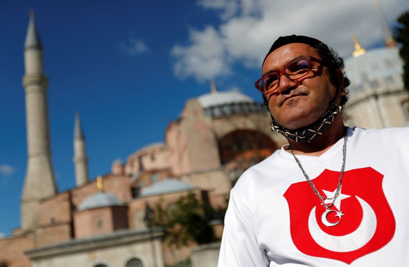 A man wears a shirt with the Turkish flag in front of the Hagia Sophia or Ayasofya, after a court decision that paves the way for it to be converted from a museum back into a mosque, in Istanbul