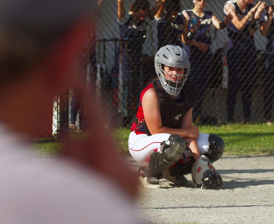 Catcher Emma Flaherty looks to B-R coach Michael Carrozza (L) for the pitch sign to give to pitcher Lily Welch on the mound, Monday, June 6, 2022.