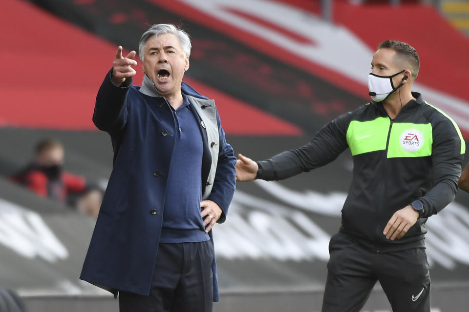 Everton's manager Carlo Ancelotti, left, shouts next to an official during an English Premier League soccer match between Southampton and Everton at the St. Mary's stadium in Southampton, England, Sunday Oct. 25, 2020. (Andy Rain/Pool via AP)