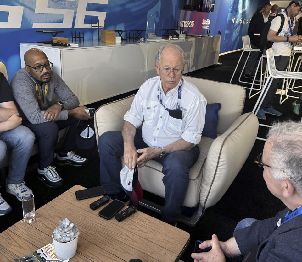 NASCAR chairman Jim France, center, speaks to reporters at the 24 Hours of Le Mans in Le Mans, France, Thursday, June 8, 2023. NASCAR has arrived at the 24 Hours of Le Mans and even though its a specialized entry that can't race for the win, just being part of the biggest endurance race in the world has the industry buzzing to be part of the global stage. (AP Photo/Jenna Fryer)