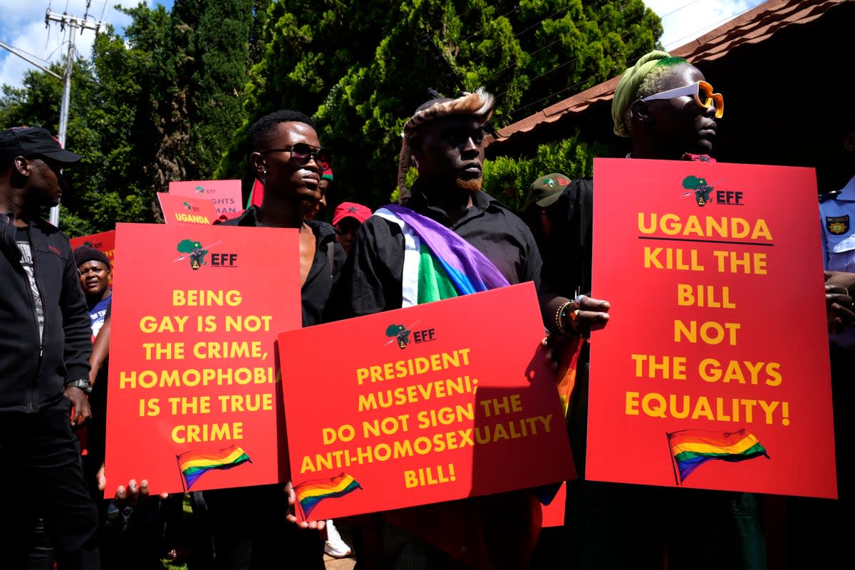 Activists hold placards during their picket against Uganda’s anti-homosexuality bill at the Ugandan High Commission in Pretoria (AP)