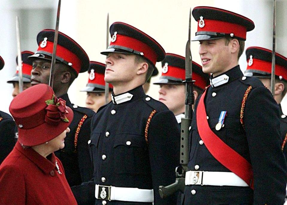 Queen Elizabeth II smiles at her grandson Prince William, right, as she inspects graduates during a graduation parade at the Royal Military Academy at Sandhurst, Dec. 15, 2006.