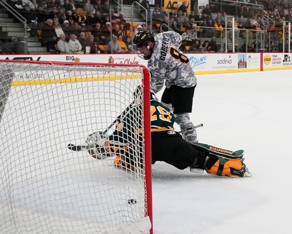 Adrian College's Zach Goberis scores a goal during the Harris Cup final against St. Norbert on March 5 at Arrington Ice Arena on the campus of Adrian College. [Telegram photo by Mike Dickie]