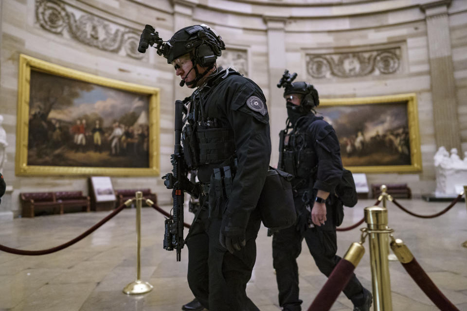 Members of the U.S. Secret Service Counter Assault Team walk through the Rotunda as they and other federal police forces responded as violent protesters loyal to President Donald Trump stormed the U.S. Capitol today, at the Capitol in Washington, Wednesday, Jan. 6, 2021. (AP Photo/J. Scott Applewhite)