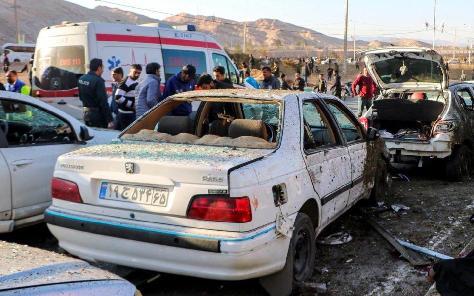 People gather at the scene of explosions during a ceremony held to mark the death of late Iranian General Qassem Soleimani, in Kerman, Iran