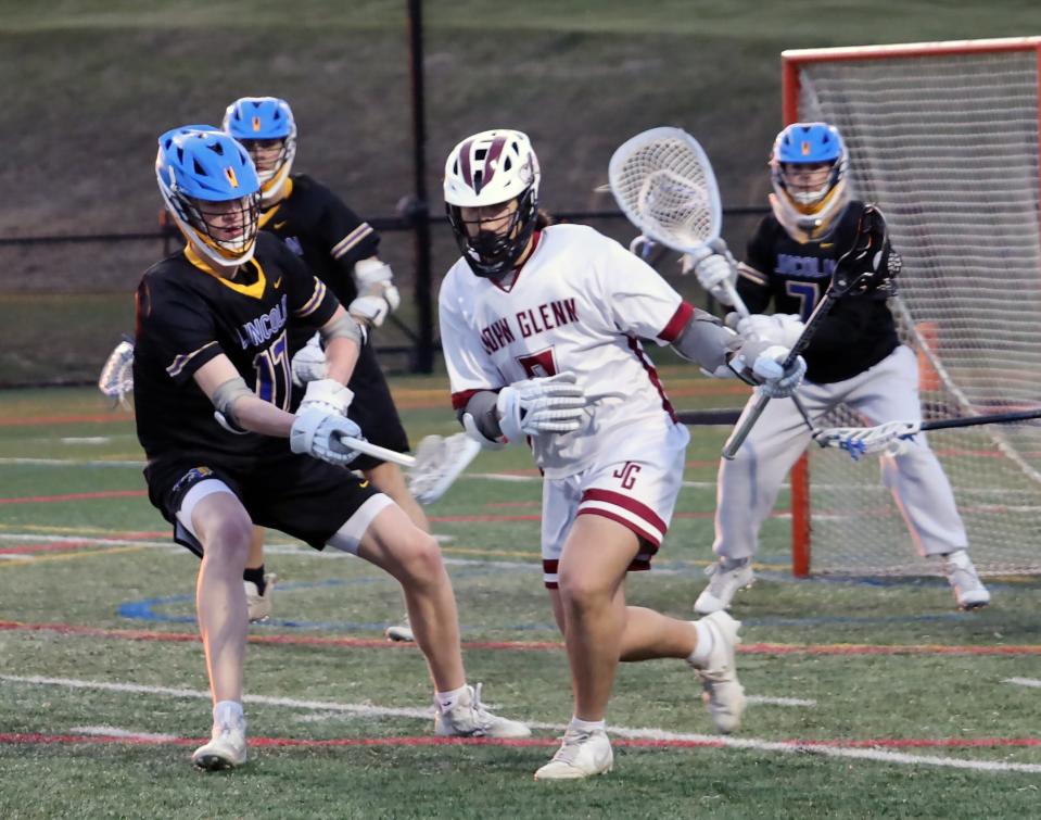 John Glenn's Cannon Fox (7) moves with the ball during the lacrosse game against Gahanna at New Concord Thursday evening.