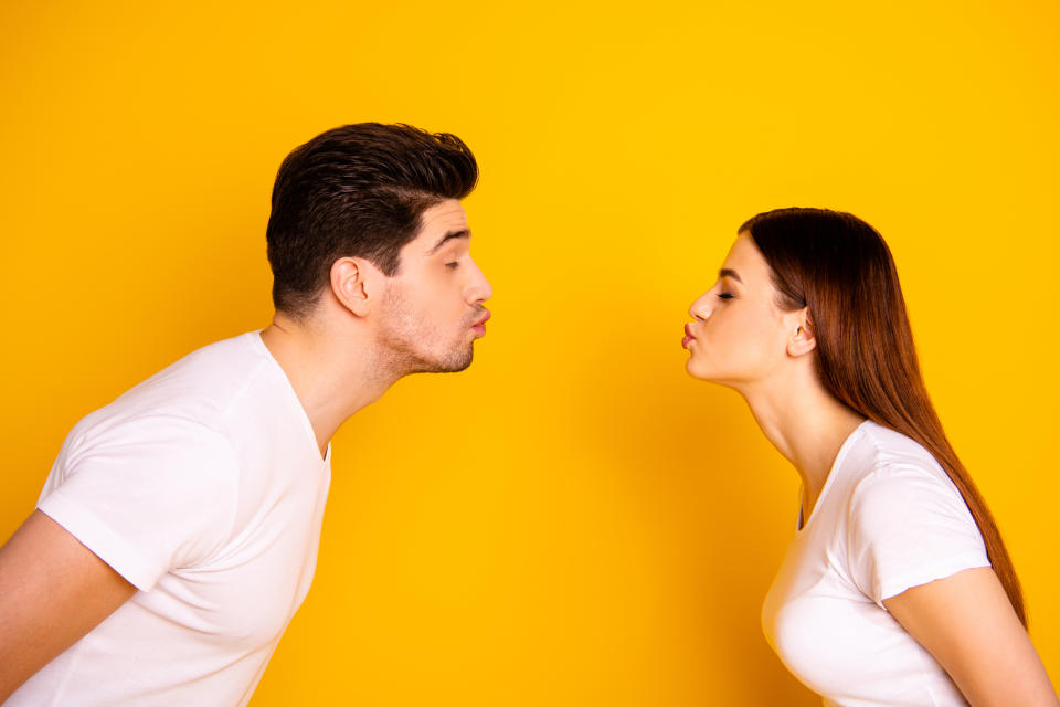 Close up side profile photo amazing beautiful she her he him his guy lady bonding ahead each other need kisses tenderness spread lips wear casual white t-shirts outfit isolated yellow background.