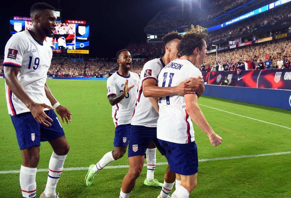 USMNT players celebrate a goal against Canada.