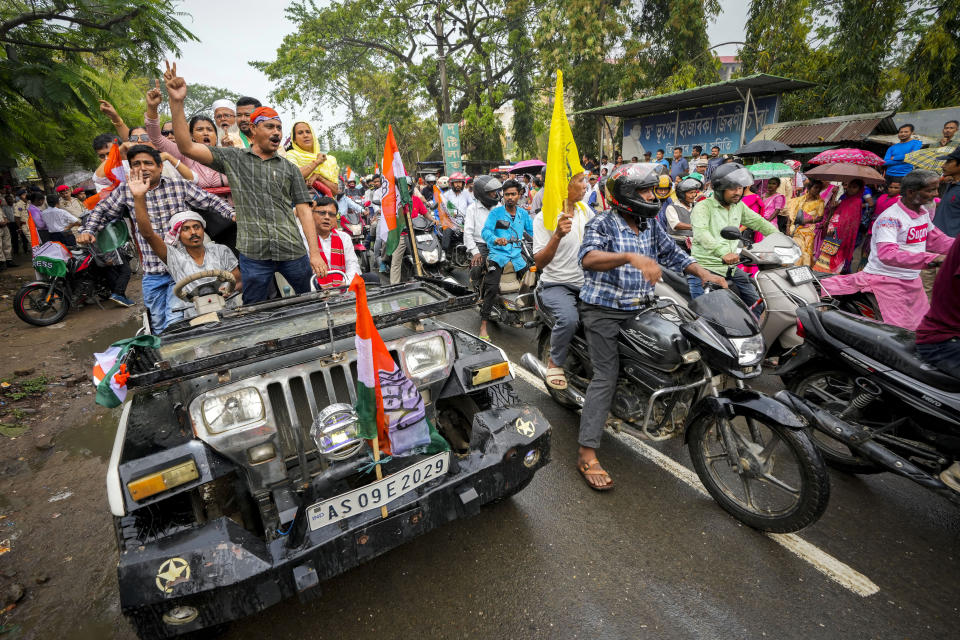 India's Congress party supporters take part in a bike rally during a road show of leader Priyanka Gandhi ahead of the first phase of national elections in Titabor in upper Assam, India, Tuesday, April 16, 2024. (AP Photo/Anupam Nath)