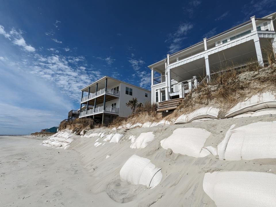 Several property owners near the west end of Oak Island have resorted to sandbags, which they've paid for, to help protect their beachfront homes after the seas washed away the dunes in front of them.