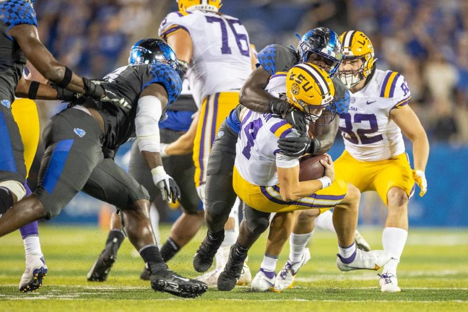 Kentucky defensive tackle Octavious Oxendine tackles LSU quarterback Max Johnson during a game at Kroger Field on Oct. 9, 2021. The Cats won 42-21.