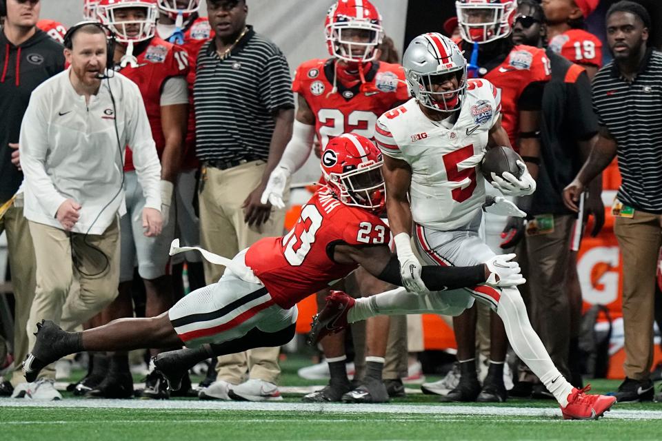 Ohio State running back Dallan Hayden is forced out of bounds by Georgia's Tykee Smith during the College Football Playoff semifinal.