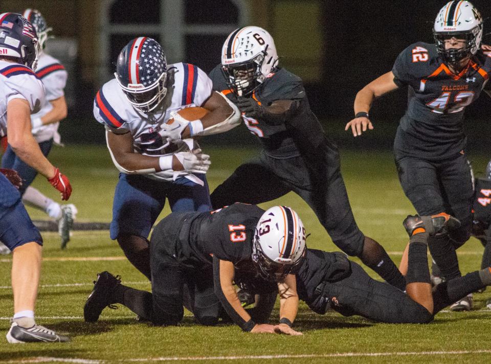 Central Bucks East's Ethan Shine (21) is stopped by Pennsbury’s Chamar Wade (6) in the second quarter of the Central Bucks East at Pennsbury football game Friday, September 30, 2022 at Harry Truman High School in Levittown, Pennsylvania. Pennsbury defeated CB East 37 to 22. (WILLIAM THOMAS CAIN/PHOTOJOURNALIST)