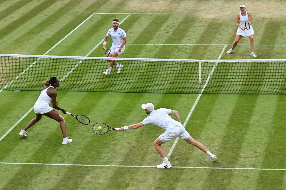 Britain's Jamie Murray (BOTTOM R) and US player Venus Williams (BOTTOM L) compete against Britain's Jonny O'Mara and Alicia Barnett during their mixed doubles tennis match on the seventh day of the 2022 Wimbledon Championships at The All England Tennis Club in Wimbledon, southwest London, on July 3, 2022. - RESTRICTED TO EDITORIAL USE (Photo by Glyn KIRK / AFP) / RESTRICTED TO EDITORIAL USE (Photo by GLYN KIRK/AFP via Getty Images)