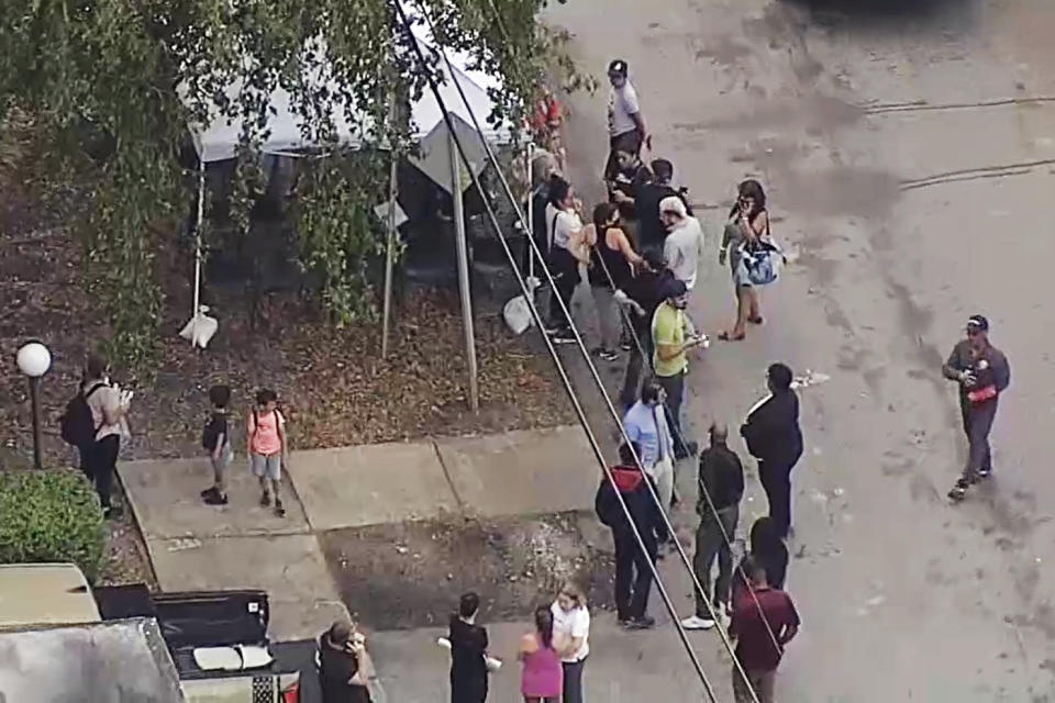 A condominium building in North Miami Beach, Fla., that was deemed structurally unsafe is evacuated Monday.  (NBC Miami)