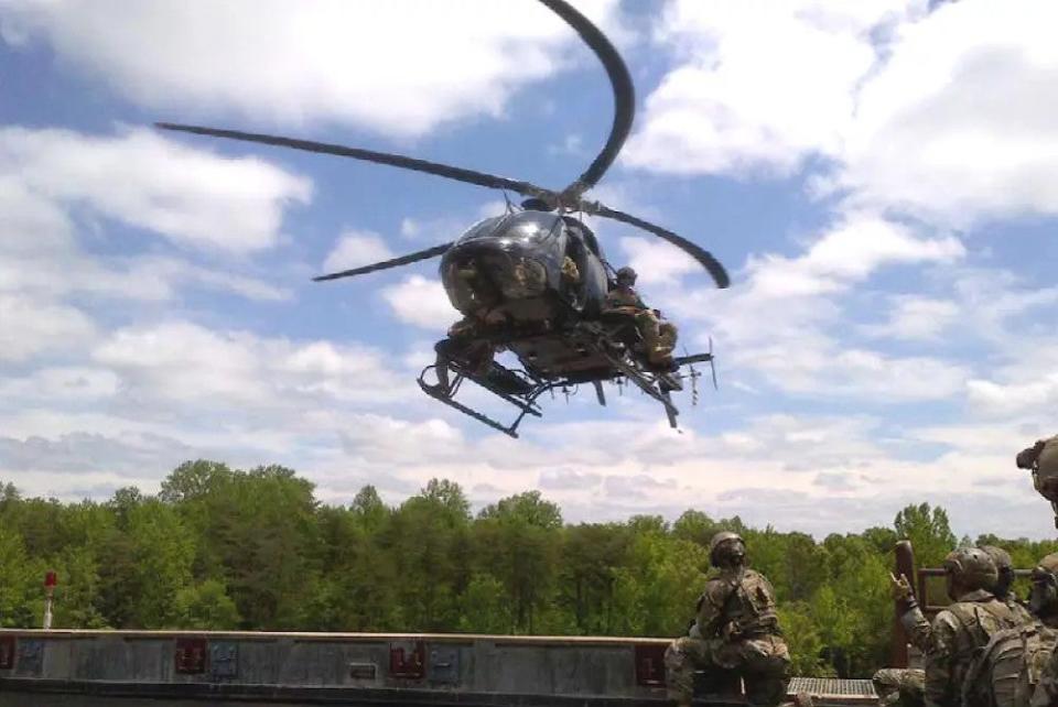 A picture of an FBI Hostage Rescue Team Bell 407, a derivative of the Bell 206 and the commercial companion to the OH-58D, fitted with added personnel planks on either side of the fuselage. <em>GAO</em>