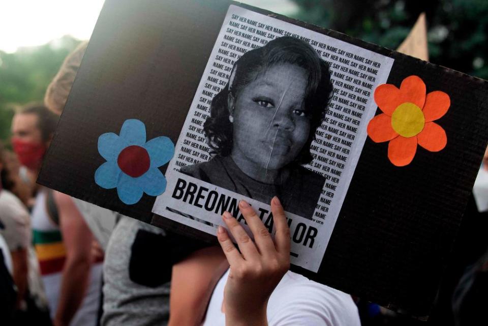 A demonstrator holds a sign with a photo of Breonna Taylor in Denver, Colorado, on 3 June.