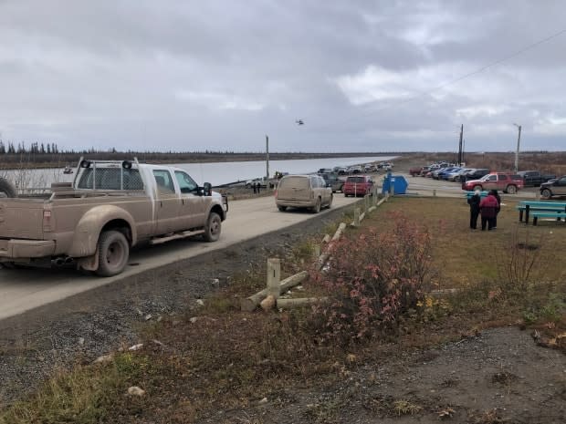 A search for a 29-year-old man, last seen in the water by the boat launch in Invuik, N.W.T., is being carried out by police, partner agencies and volunteers.   (Mackenzie Scott/CBC - image credit)