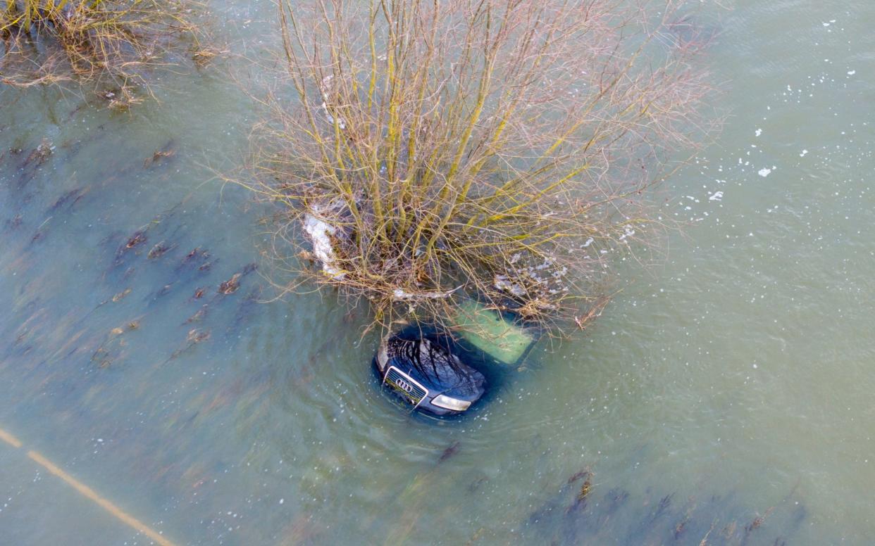 An Audi submerged after it got caught out on Britain's lowest road, the A1101 in Welney Norfolk which is flooded