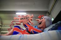 <p>A carnival float, depicting Britain’s Prime Minister Theresa May giving birth to the Brexit, is being prepared at a warehouse ahead of a carnival parade on Rose Monday on Feb. 12, 2018 in Duesseldorf, southern Germany. (Photo: Marcel Kusch/Getty Images) </p>