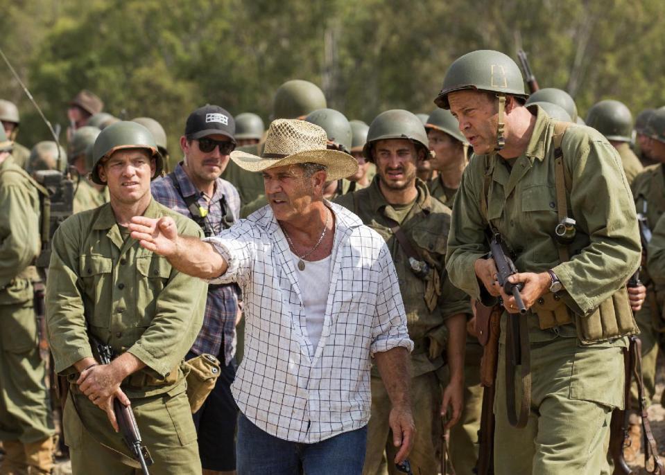 This image released by Summit shows director Mel Gibson, center, and actor Vince Vaughn on the set of the film, "Hacksaw Ridge." Gibson was nominated for an Oscar for best directing on Tuesday, Jan. 24, 2017, for his work on the film. The 89th Academy Awards will take place on Feb. 26. (Summit via AP)