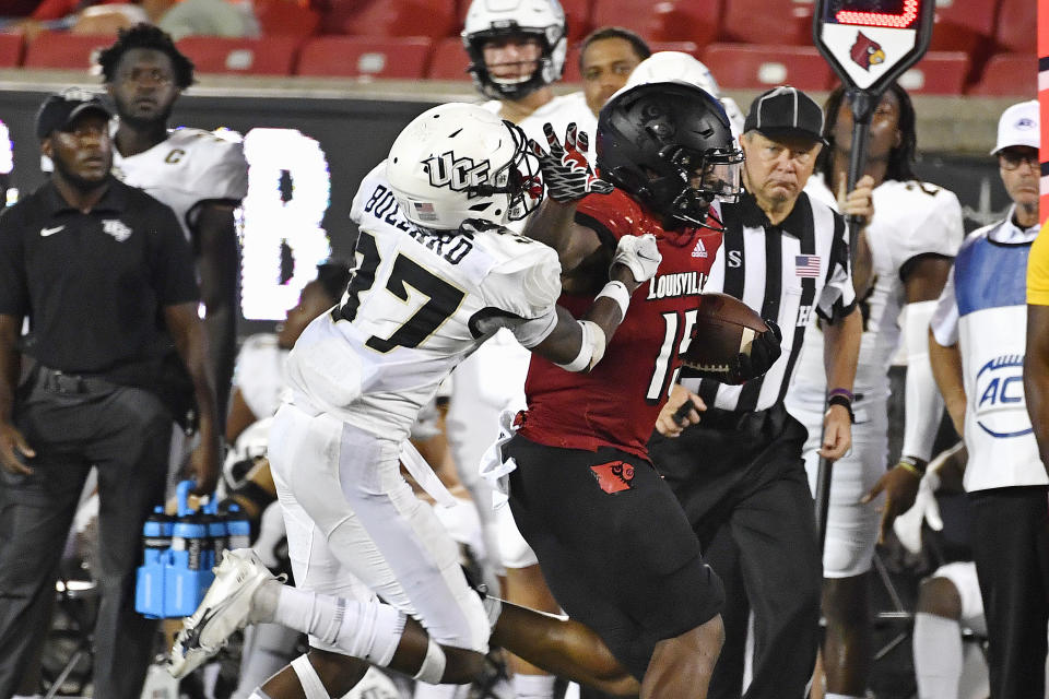 Central Florida defensive back Quadric Bullard (37) attempts to tackle Louisville running back Jalen Mitchell (15) during the second half of an NCAA college football game in Louisville, Ky., Friday, Sept. 17, 2021. (AP Photo/Timothy D. Easley)