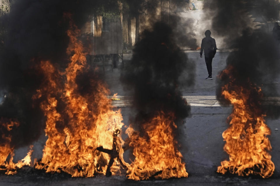 Palestinian demonstrators burn tires in a protest against a deadly Israeli army raid at Aida Refugee camp, in the West Bank city of Bethlehem, Thursday, Jan. 26, 2023. During the raid in the West Bank town of Jenin, Israeli forces killed at least nine Palestinians, including a 60-year-old woman, and wounded several others, Palestinian health officials said, in one of the deadliest days of fighting in years. The Israeli military said it was conducting an operation to arrest militants when a gun battle erupted. (AP Photo/Mahmoud Illean)