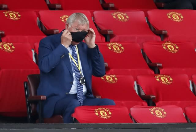 Former Manchester United Sir Alex Ferguson adjusts his face mask at Old Trafford. The 78-year-old watched from the stands as United ... against West Ham