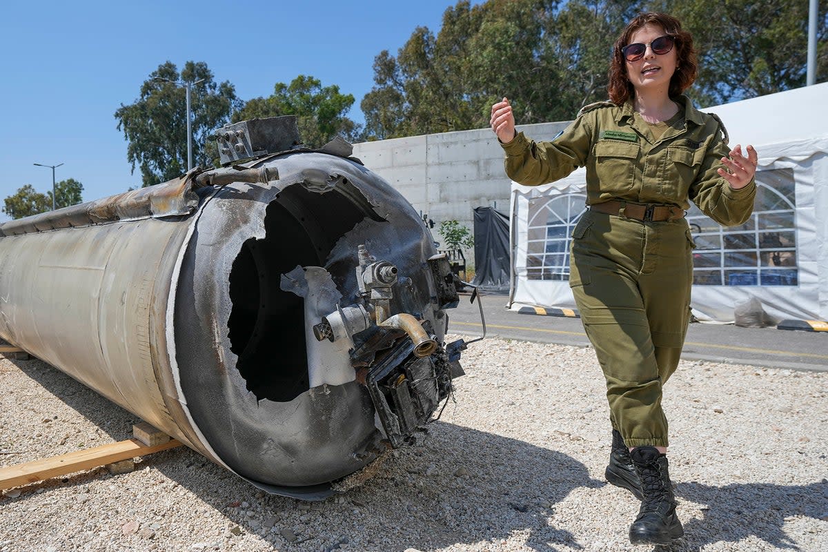 Israeli military deputy head of the IDF international press department, first lieutenant Masha Michelson, displays to the media one of the intercepted Iranian ballistic missiles  (AP Photo/Tsafrir Abayov)