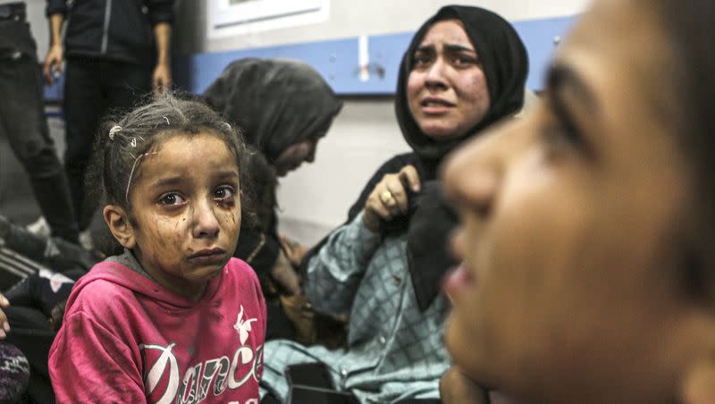 Wounded Palestinians sit in al-Shifa hospital in Gaza City, central Gaza Strip, after arriving from al-Ahli hospital following an explosion there, Tuesday, Oct. 17, 2023. The Hamas-run Health Ministry says an Israeli airstrike caused the explosion that killed hundreds at al-Ahli, but the Israeli military says it was a misfired Palestinian rocket. 