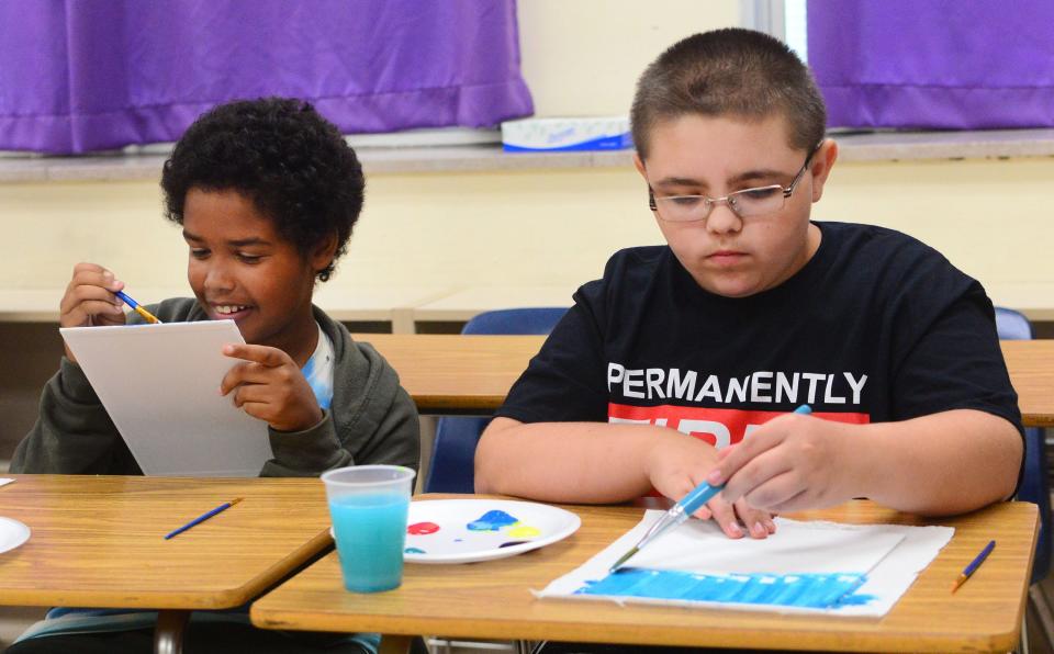 Quincy Taylor, left, and Sylar Gindlesperger paint during a welcome back event Thursday, Aug. 17, 2023, at Sebring McKinley Jr./Sr. High School.