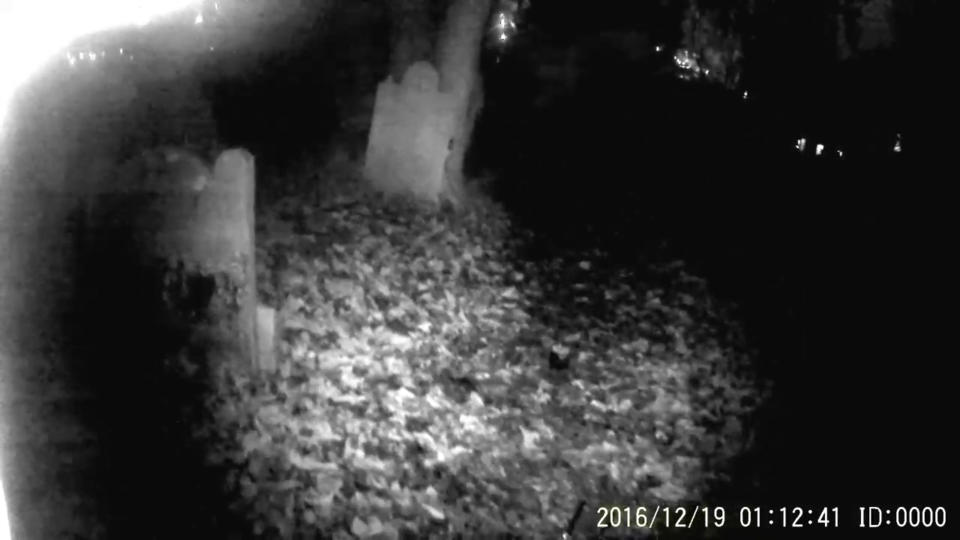 A fitness coach claims to have captured the spine-tingling moment a ghost flew straight at his camera as he explored an eerie 800-year-old graveyard. Photo: Caters News