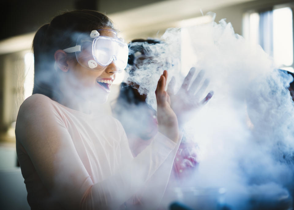 Girl surprised by a smokey science experiment. 