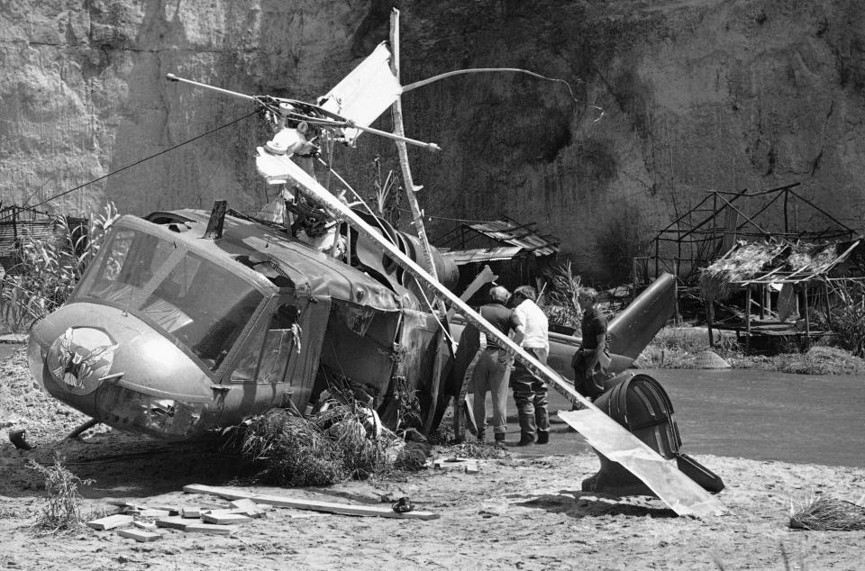 Investigators look over wreckage of helicopter which crashed during filming of a movie in a private park near Castaic, California on Friday, July 23, 1982. The crash killed veteran actor Vic Morrow and two child actors during filming of scene in a movie revival of “The Twilight Zone.” (AP Photo/Scott Harms)