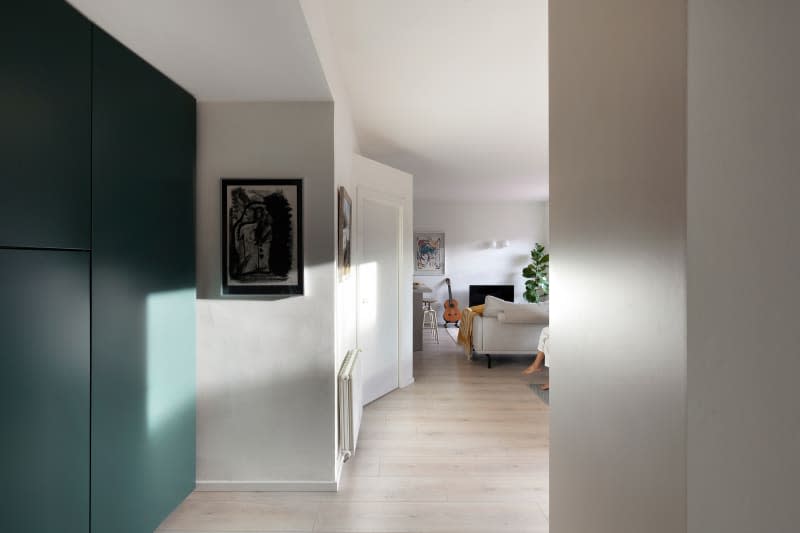 Entryway with green built-in murphy bed and white walls.