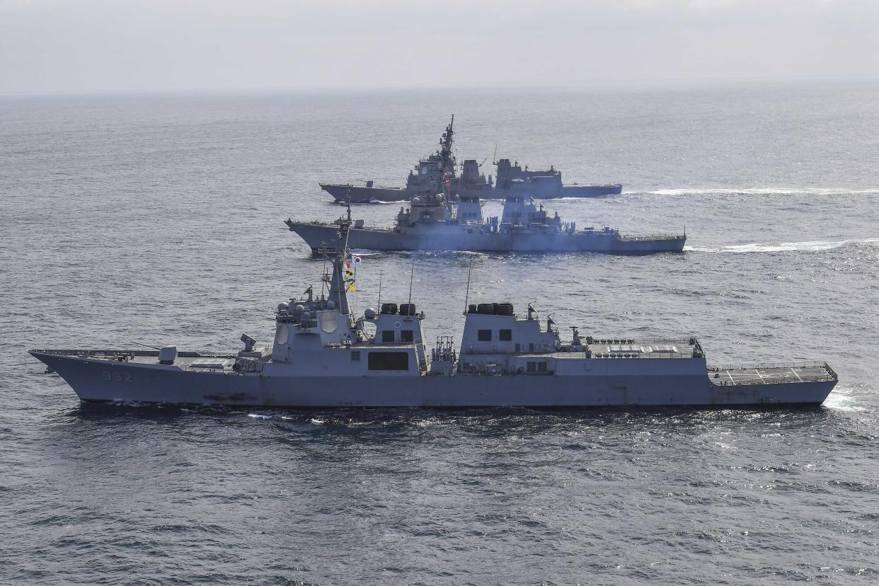 In this photo provided by South Korea Defense Ministry, South Korean Navy's destroyer Yulgok Yi I, bottom, U.S. Navy's the guided missile destroyer USS Benfold and Japan Maritime Self-Defense Force's destroyer Atago, top, sail during a joint missile defense drill among South Korea, the United States and Japan in the international waters of the east coast of Korean peninsular, Monday, April 17, 2023. The United States, South Korea and Japan will conduct a joint missile defense exercise Monday in waters near the Korean Peninsula as they expand military training to counter the growing threats of North Korea's nuclear-capable missiles, the South Korean navy said. (South Korea Defense Ministry via AP)