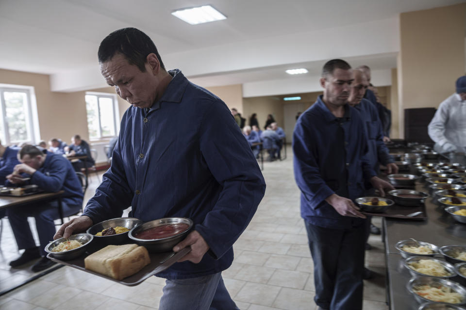 Russian prisoners of war pick up their lunches at a detention center in Ukraine's Lviv region, Thursday, April 25, 2024. AP visited the center as part of a small group of journalists on the condition that its exact location be withheld. (AP Photo/Evgeniy Maloletka)