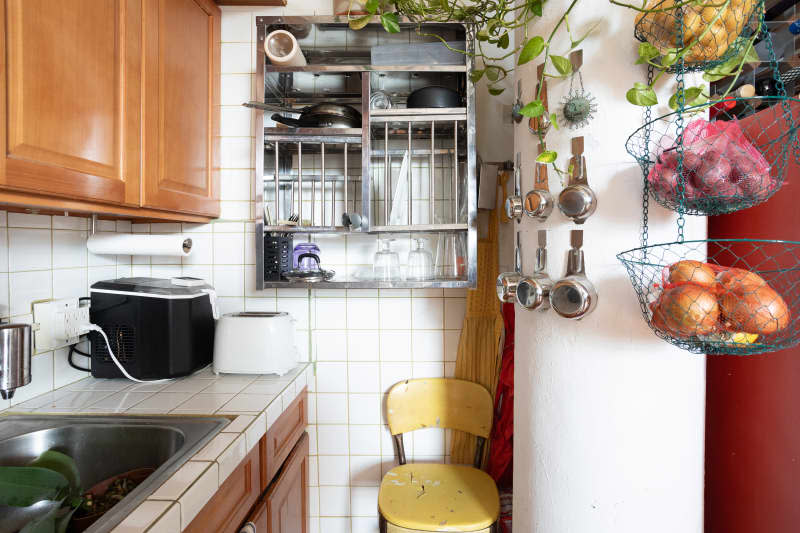 Measuring cups hung on column in kitchen.