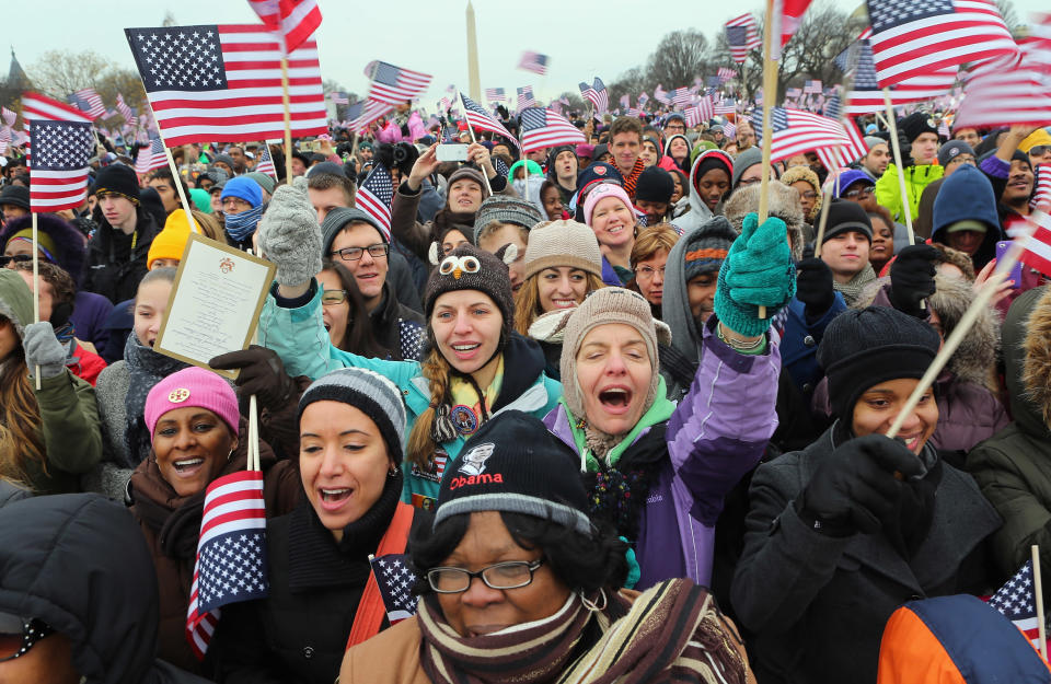 People cheer as on the National Mall during the Inauguration ceremony on January 21, 2013 in Washington, DC. U.S. President Barack Obama was sworn in during his public ceremonial swearing-in ceremony for his second term today. (Photo by Joe Raedle/Getty Images)