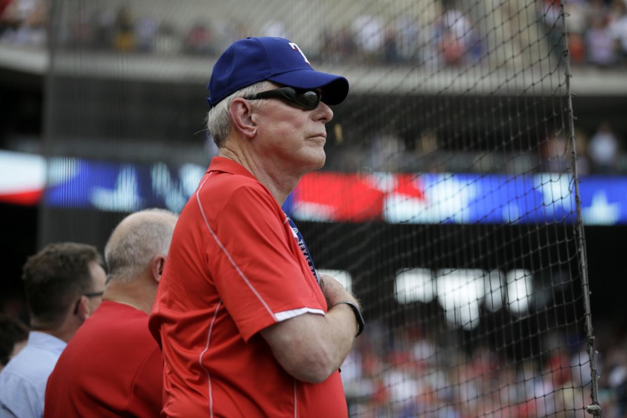 Texas Rangers co-chairman Ray Davis stands during the national anthem.