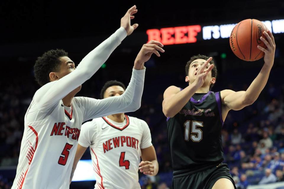 Campbell County’s Garyn Jackson (15) challenges Newport’s James Turner (4) and Griffin Starks (5). Jackson finished with 11 points, six rebounds and four assists for the Camels. James Crisp