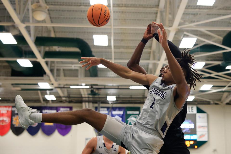 UNF guard Chaz Lanier (2) battles JU's Osayi Osifo for a loose ball during a River City Rumble game last season at Swisher Gym.