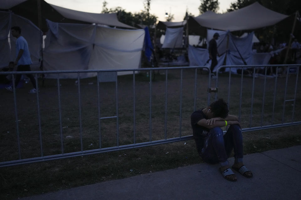 Hundreds of migrants who seek shelter prepare to sleep outside an overcrowded asylum seekers center in Ter Apel, northern Netherlands, Thursday, Aug. 25, 2022. (AP Photo/Peter Dejong)